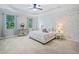 Spacious primary bedroom boasts a tray ceiling and white brick accent wall at 2801 Avington Se Ln, Smyrna, GA 30080