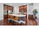 Stylish kitchen featuring a spacious island with bar seating, dark wood cabinets, and modern appliances at 2801 Avington Se Ln, Smyrna, GA 30080