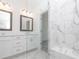 Modern bathroom with double vanity, framed mirrors, and glass-enclosed shower with seat at 4253 Millcroft Pl # 198, Buford, GA 30518