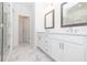 Modern bathroom with double vanity, framed mirrors, glass-enclosed shower, and stylish fixtures at 4253 Millcroft Pl # 198, Buford, GA 30518