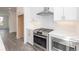 Bright kitchen showcasing stainless steel appliances, white cabinets, quartz countertops, and an open layout concept at 4253 Millcroft Pl # 198, Buford, GA 30518
