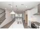Contemporary kitchen with white cabinets, quartz countertops, stainless appliances, large island, and views to the living area at 4253 Millcroft Pl # 198, Buford, GA 30518