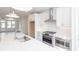 Modern kitchen featuring stainless steel appliances, quartz countertops, white cabinets, and an open layout with an island at 4253 Millcroft Pl # 198, Buford, GA 30518