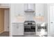 White kitchen features stainless steel appliances, subway tile backsplash and white countertops, with natural light from a nearby window at 4253 Millcroft Pl # 198, Buford, GA 30518