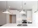 Close up on a kitchen with white cabinets, subway tile backsplash, stainless steel appliances, and large island at 4253 Millcroft Pl # 198, Buford, GA 30518