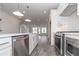 Open concept kitchen with island, stainless steel appliances, and easy access to the living area in a modern design at 4253 Millcroft Pl # 198, Buford, GA 30518