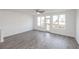 Spacious living room with hardwood flooring, plenty of natural light, and outdoor access at 4253 Millcroft Pl # 198, Buford, GA 30518