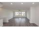 Open living room features hardwood flooring, natural light, and access to outdoor balcony at 4253 Millcroft Pl # 198, Buford, GA 30518