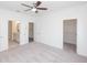 Spacious main bedroom with plush carpeting, fan, closet, and ensuite bathroom access at 4253 Millcroft Pl # 198, Buford, GA 30518