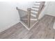 Elegant staircase with wooden handrail and sleek vinyl flooring at 4253 Millcroft Pl # 198, Buford, GA 30518