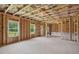 Spacious unfinished basement featuring framed walls and windows overlooking a wooded area at 7252 Eton Ln, Locust Grove, GA 30248