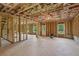 Large unfinished basement featuring framed walls, exterior access, and windows overlooking a wooded area at 7252 Eton Ln, Locust Grove, GA 30248