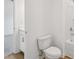 Cozy bathroom featuring a standard toilet, shower-tub combo, and view to bedroom at 7252 Eton Ln, Locust Grove, GA 30248