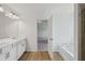 Elegant bathroom with double vanity, white cabinets, and wood-look flooring at 7252 Eton Ln, Locust Grove, GA 30248