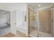 Bright bathroom featuring a tiled shower, soaking tub, and neutral color scheme at 7252 Eton Ln, Locust Grove, GA 30248