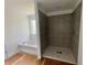 Bathroom showcasing a soaking tub, a separate tiled shower, and natural light at 7252 Eton Ln, Locust Grove, GA 30248