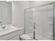 A modern bathroom with a glass-enclosed shower, vanity, and toilet at 7252 Eton Ln, Locust Grove, GA 30248