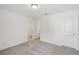 Spacious bedroom featuring neutral carpet and two doors for easy access throughout the home at 7252 Eton Ln, Locust Grove, GA 30248