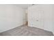 Spacious bedroom with gray carpet flooring, a closet, and an open doorway at 7252 Eton Ln, Locust Grove, GA 30248