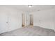 Bright bedroom featuring neutral carpet and two doors for easy access throughout the home at 7252 Eton Ln, Locust Grove, GA 30248