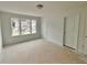 Bedroom featuring three windows and closet providing ample natural light and storage at 7252 Eton Ln, Locust Grove, GA 30248