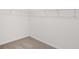 Walk-in closet with wire shelving and neutral carpeting at 7252 Eton Ln, Locust Grove, GA 30248