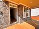 Covered entrance featuring stone accents, white trim, and an inviting doorway at 7252 Eton Ln, Locust Grove, GA 30248