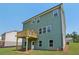 View of the home's back exterior featuring an outdoor deck and lots of windows at 7252 Eton Ln, Locust Grove, GA 30248
