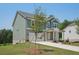 Charming home with a stone facade, green paneled upper-story, a two-car garage, and a well-manicured front lawn at 7252 Eton Ln, Locust Grove, GA 30248