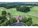 An aerial view of a beautiful golf course, surrounded by lush trees at 7252 Eton Ln, Locust Grove, GA 30248