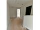 Upstairs hallway featuring white walls and doors, with access to bedrooms at 7252 Eton Ln, Locust Grove, GA 30248