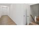 Hallway with a door leading to the exterior of the home, and a stairwell leading to the basement at 7252 Eton Ln, Locust Grove, GA 30248