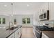 Modern kitchen with white cabinets, stainless steel appliances, and quartz countertops at 7252 Eton Ln, Locust Grove, GA 30248