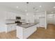 Modern kitchen featuring stainless steel appliances, a center island with a sink, and white cabinets at 7252 Eton Ln, Locust Grove, GA 30248