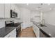 Modern kitchen with stainless steel appliances, white cabinets, subway tile backsplash, and an island with a sink at 7252 Eton Ln, Locust Grove, GA 30248