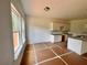 Bright kitchen featuring white cabinets, granite counters, and plenty of natural light from the windows at 7252 Eton Ln, Locust Grove, GA 30248