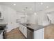 Bright kitchen with a large island, stainless steel appliances and wood-look floors at 7252 Eton Ln, Locust Grove, GA 30248