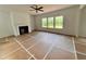 Spacious living room featuring a fireplace, large windows and neutral wall colors at 7252 Eton Ln, Locust Grove, GA 30248