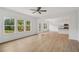 Open-concept living room with wood-look floors and plenty of natural light at 7252 Eton Ln, Locust Grove, GA 30248