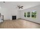 Spacious living room with fireplace and large windows overlooking a treed yard at 7252 Eton Ln, Locust Grove, GA 30248