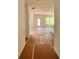 Open-concept living area with natural light and a view into the kitchen with an island at 7252 Eton Ln, Locust Grove, GA 30248