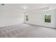 Large main bedroom with carpeted floors and tray ceiling at 7252 Eton Ln, Locust Grove, GA 30248
