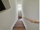 Well lit stairway with carpeted steps and a handrail up to the next level at 7252 Eton Ln, Locust Grove, GA 30248