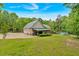 Backyard view includes covered patio, pool, and a swing set bordered by mature trees at 4332 Brushy Mountain Rd, Rockmart, GA 30153