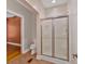Bathroom featuring tiled flooring, a glass-enclosed shower, and access to a bedroom at 4332 Brushy Mountain Rd, Rockmart, GA 30153