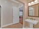 Bathroom featuring a pedestal sink, ornate mirror, and tile floors at 4332 Brushy Mountain Rd, Rockmart, GA 30153