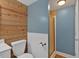 Bathroom with rustic wood accent wall, blue paint and a walk-in shower at 4332 Brushy Mountain Rd, Rockmart, GA 30153
