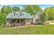 Charming brick home features a covered front porch, a metal roof, and a well-manicured front lawn at 4332 Brushy Mountain Rd, Rockmart, GA 30153