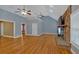 Open living area with hardwood floors, a vaulted ceiling, and a stone fireplace at 4332 Brushy Mountain Rd, Rockmart, GA 30153