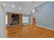 Spacious living room featuring hardwood floors, stone fireplace, and ample natural light at 4332 Brushy Mountain Rd, Rockmart, GA 30153